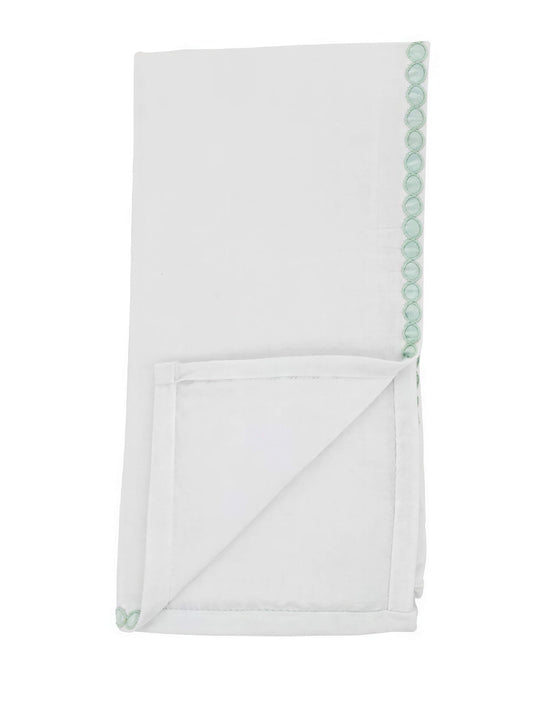 Folded white rectangular fabric napkin with a light green lace border along one edge.