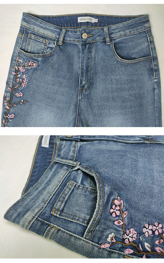 Light blue denim jeans shown in two views: a top-down view displaying the front pockets and waistband, and a folded view highlighting the floral embroidery on the pocket area.