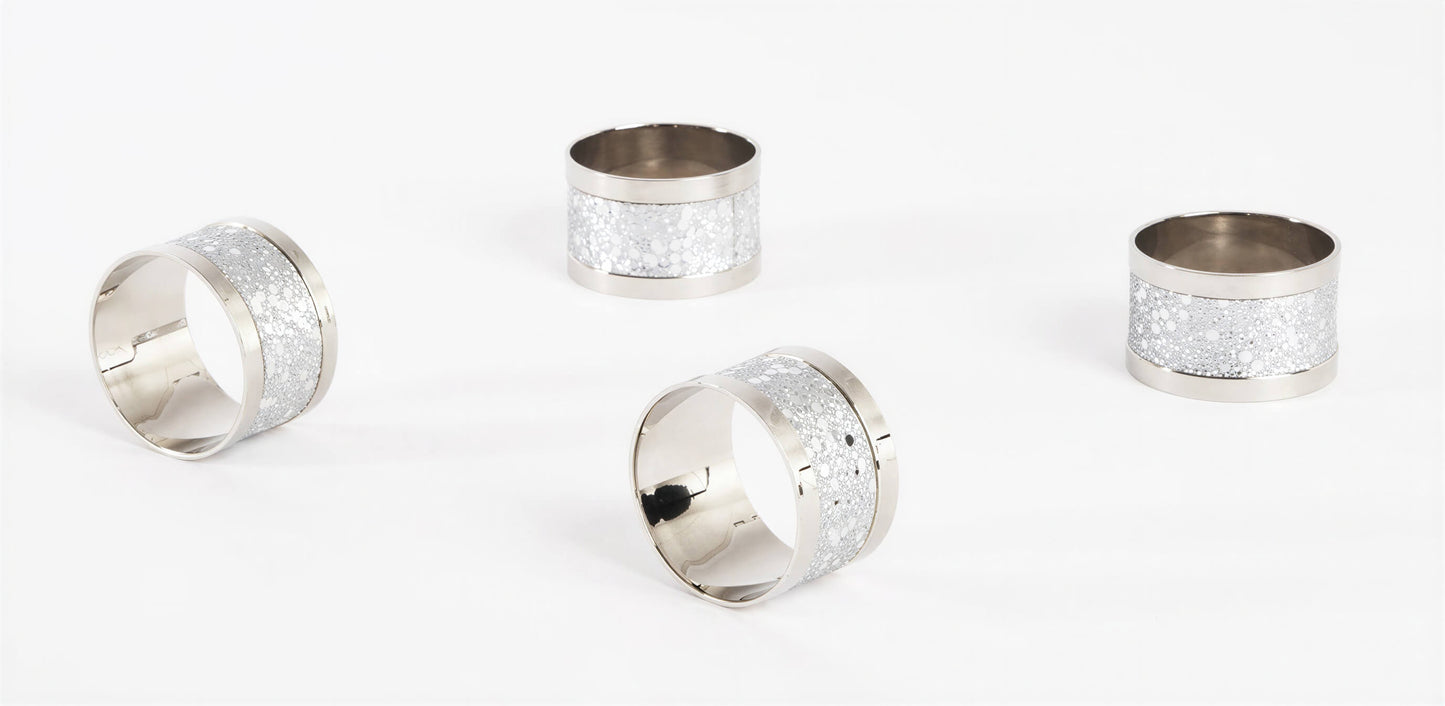 Four silver-toned napkin rings with textured glittery white bands, arranged on a clean white background.