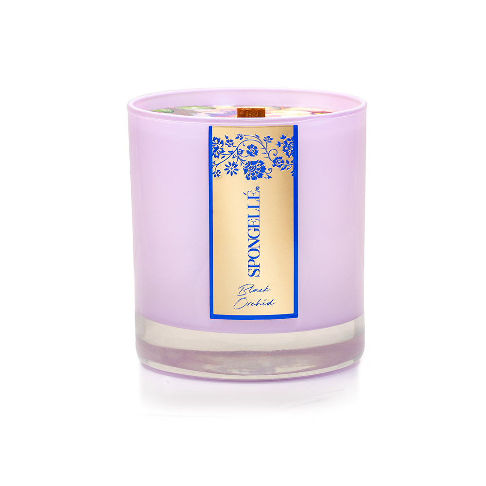 Black Orchid Private Reserve candle in a purple glass jar with a gold and blue label, featuring floral designs.