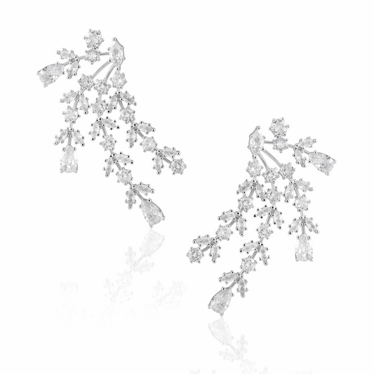 Florence silver statement earrings with branching clusters of clear stones and pear-shaped drops on a white background.