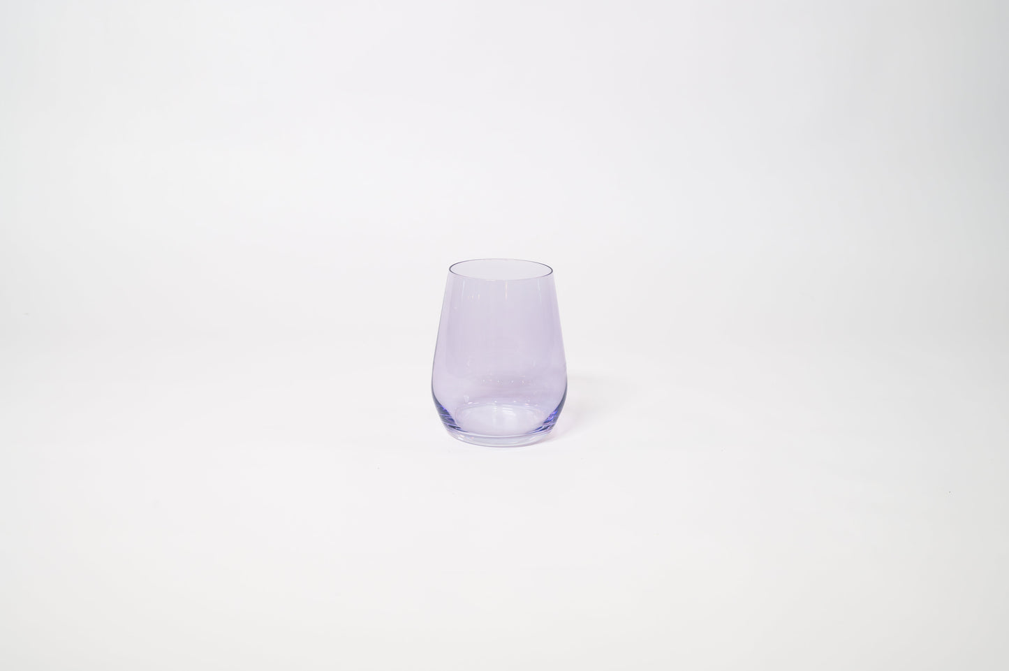 Lady Lavender colored wine glass in a soft purple hue, featuring a modern, curved design on a white background.