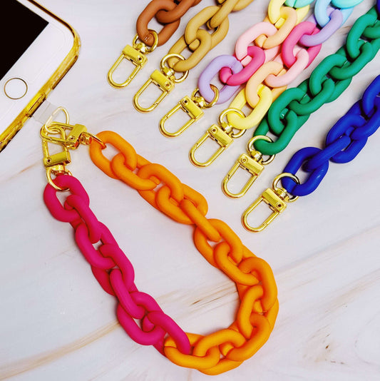 Colorful chain strap with gold clasp on a white surface
