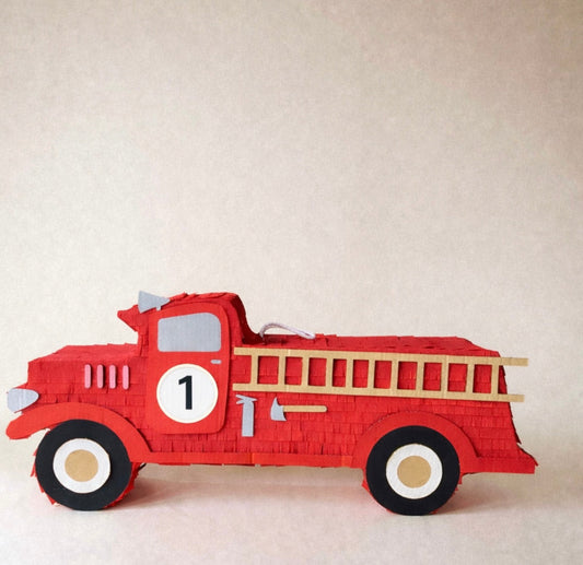 Red fire truck piñata with a tan ladder, black wheels, and the number 1 printed on the side.