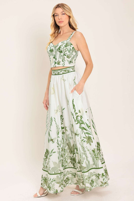 Woman wearing a green and white floral dress on a white background