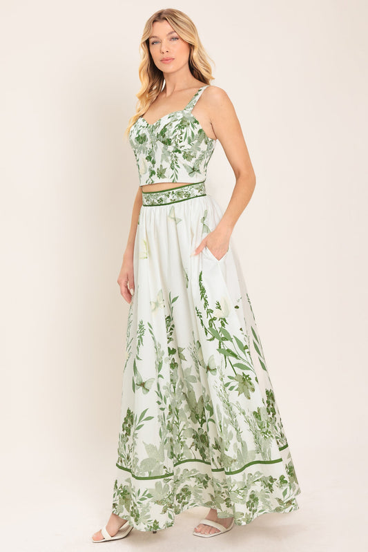 Woman wearing a green and white floral dress on a white background