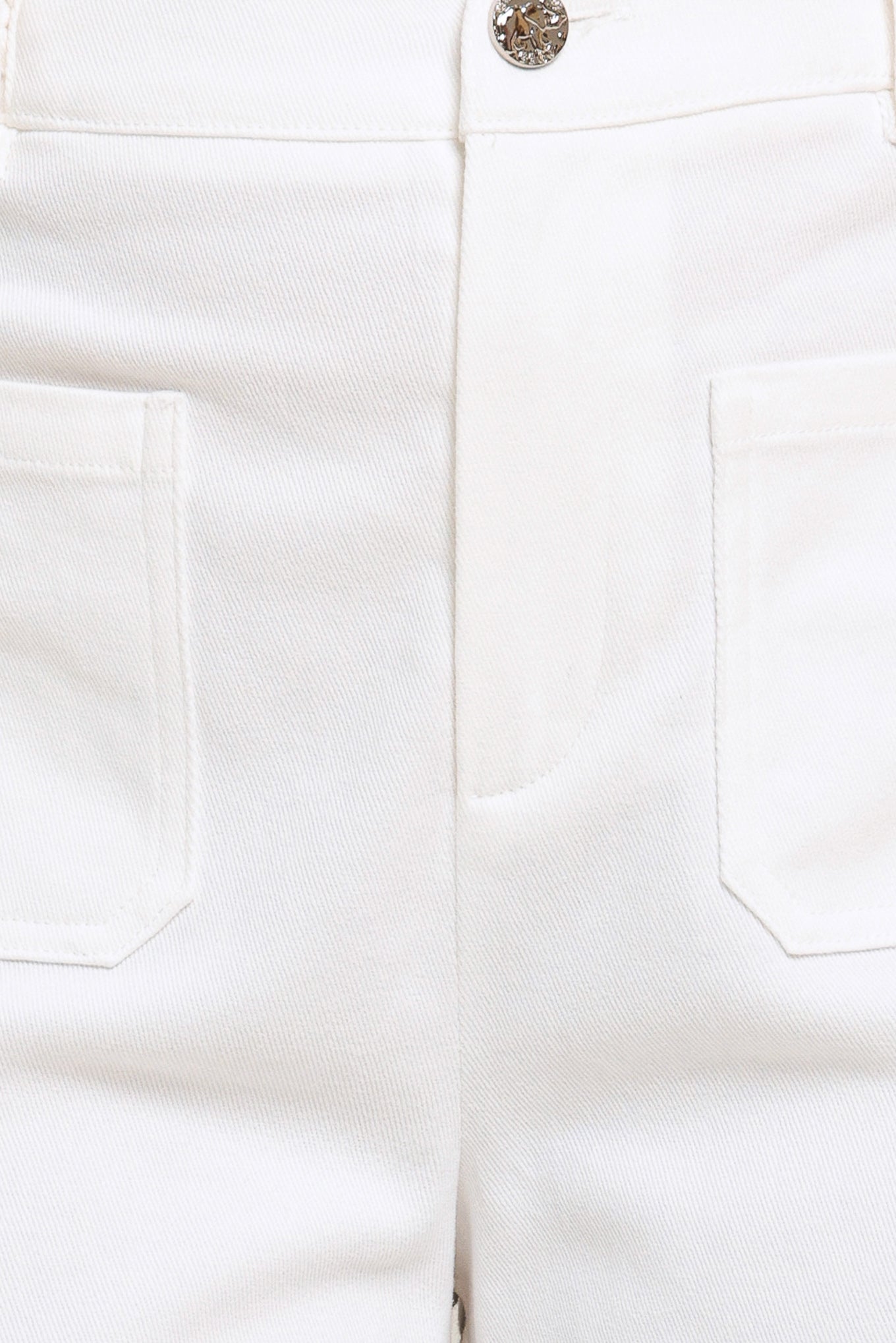 Close-up of white pants with a button and pocket details.