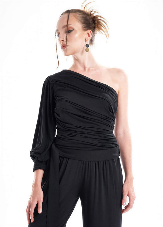 Asymmetrical one-sleeve black blouse with draped detailing paired with matching palazzo pants.