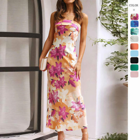 Satin strapless backless midi dress with a floral pattern in pink and orange, featuring a side slit and fitted silhouette.