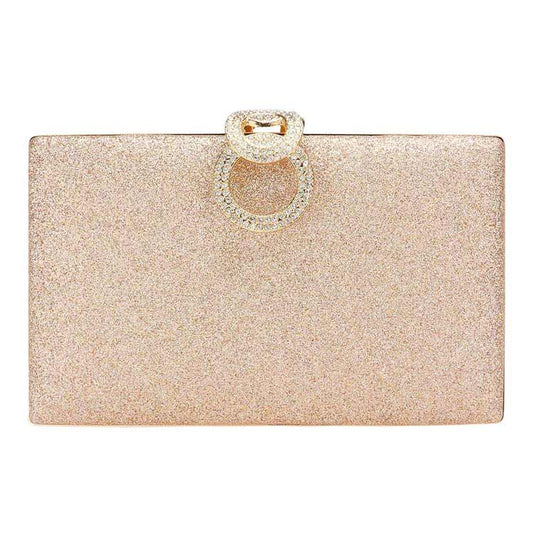 Glittery clutch bag with a decorative ring on a white background