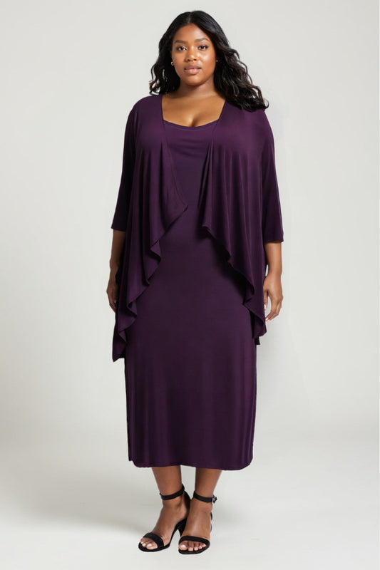 Woman wearing a purple dress with a draped effect on a white background