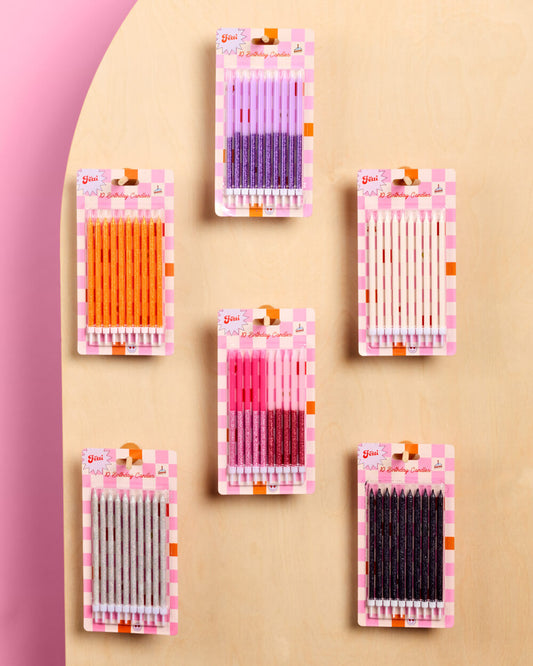 Packets of colorful needles on a pink and beige background