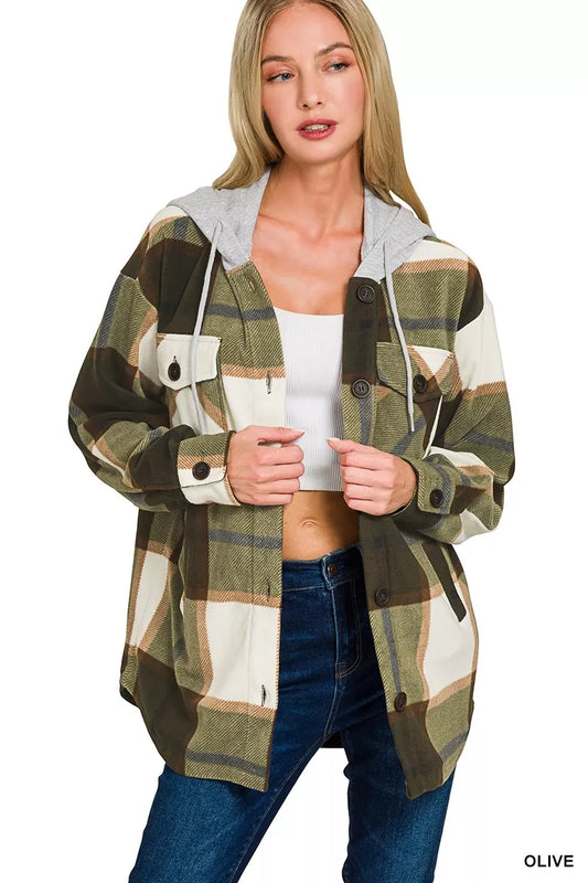 Woman wearing a plaid shirt with a hood on a white background