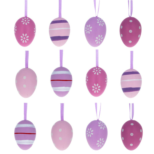 Twelve purple and pink plastic egg ornaments with floral, stripe, and dot patterns hanging from ribbons in three rows.