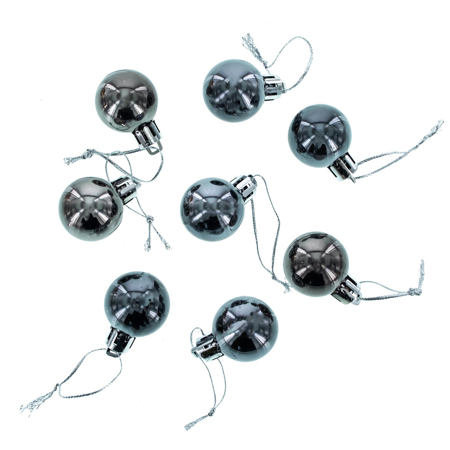 Eight round, shiny dark grey plastic ball ornaments with silver hanging strings scattered on a white background.