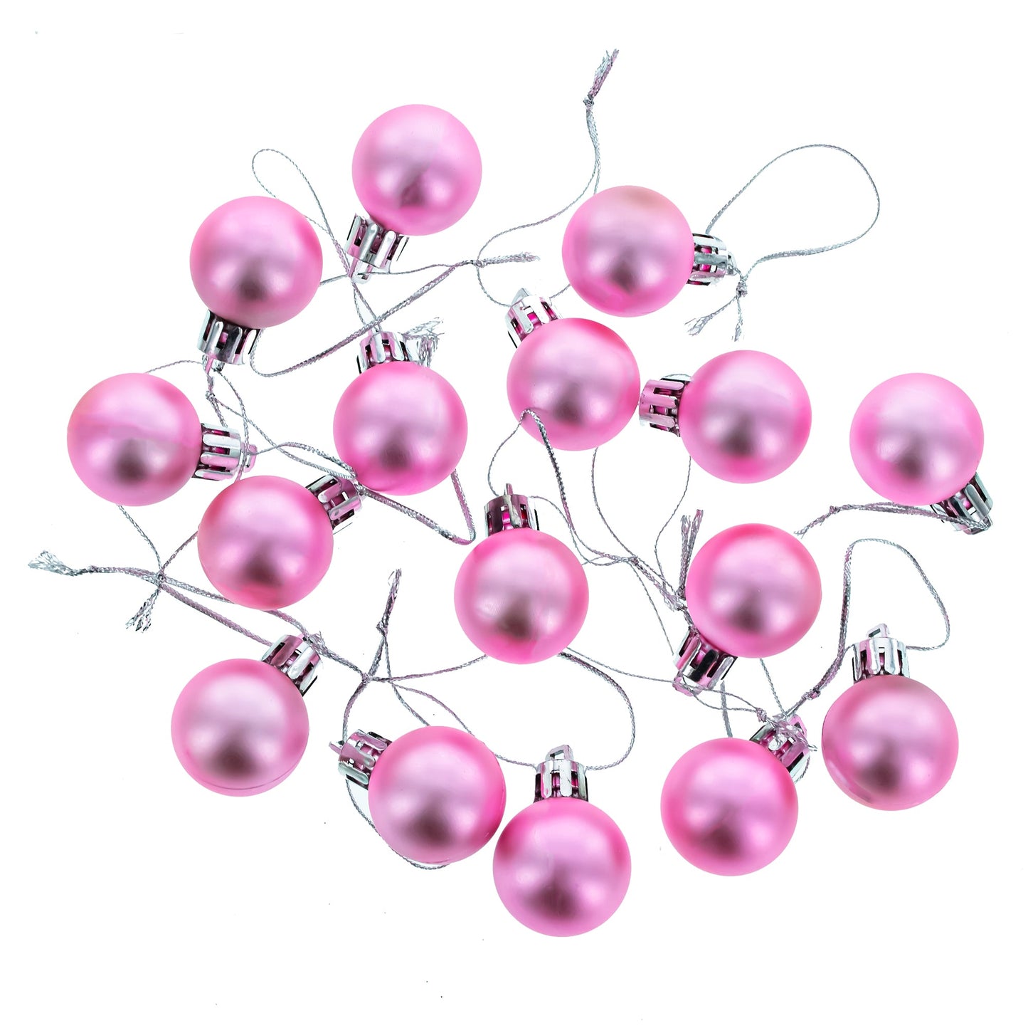 Nineteen pink matte plastic ball ornaments with silver caps and strings scattered on a white background.