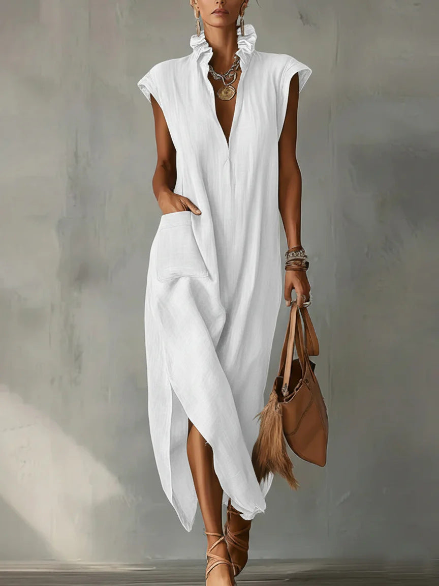 Woman wearing a white dress holding a brown leather bag against a neutral background