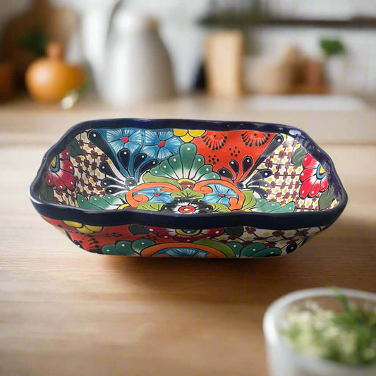 Colorful ceramic dish with intricate patterns on a wooden surface