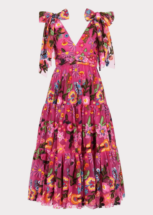 Colorful floral dress with bow straps on a white background