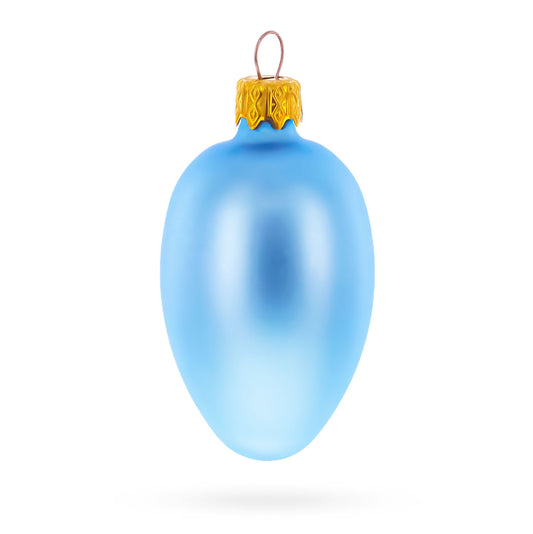 Single light blue matte glass egg ornament with a gold metal cap and wire loop against a white background.