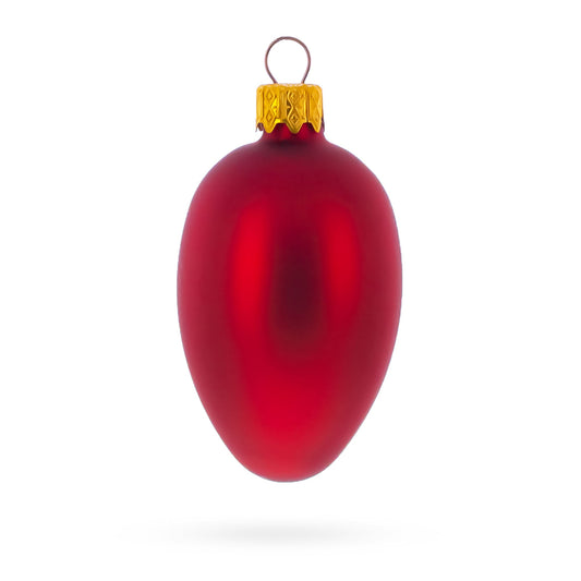 Single matte red glass egg ornament with a gold metal cap and wire loop against a white background.