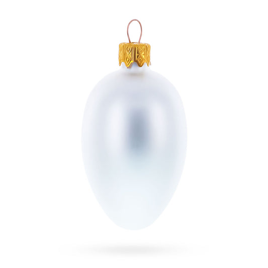Single matte white egg-shaped glass ornament with a gold metal cap and wire loop.