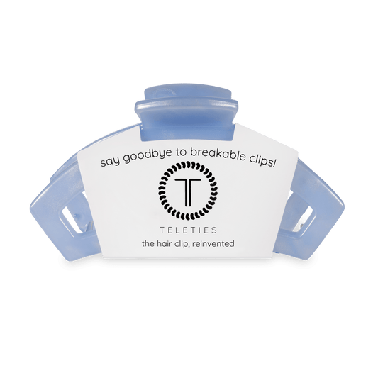 Blue hair clip with a white label featuring the Teleties logo on a transparent background