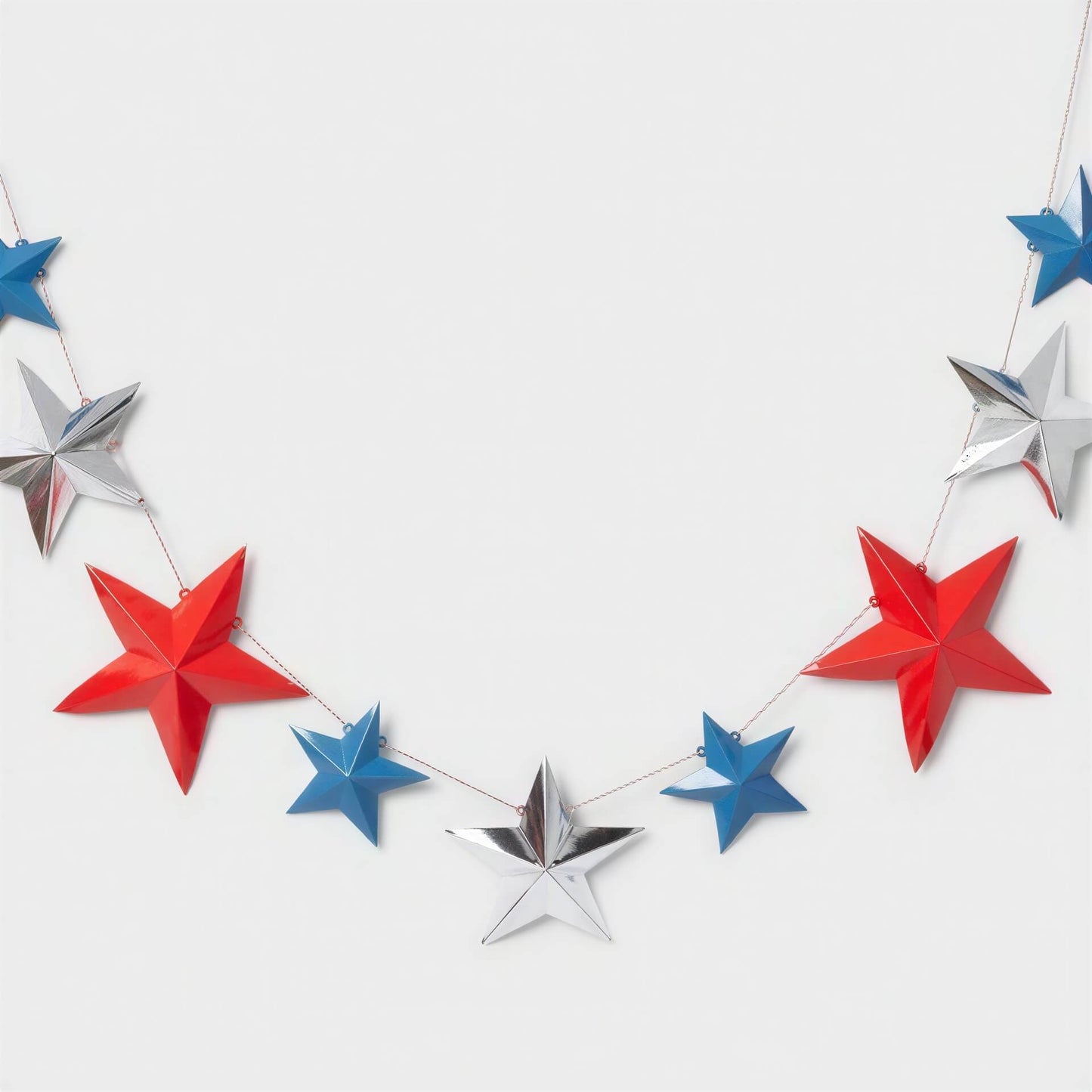 3D paper star dangler party decorations in red, white, and blue, featuring nine stars of varying sizes.