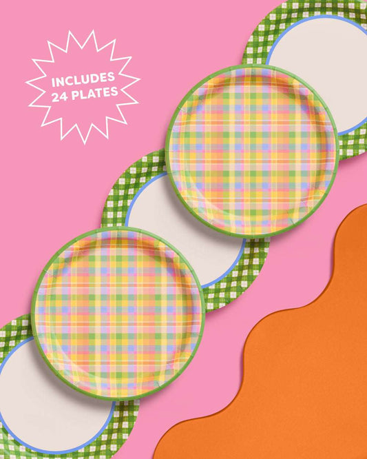 Two round paper plates with a colorful plaid pattern on a pink and orange background. Text: Includes 24 plates.