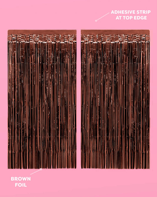 Brown foil strip with adhesive strip at top edge on a pink background