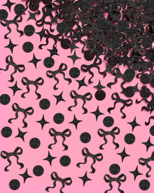 Black decorative confetti shapes on a pink background