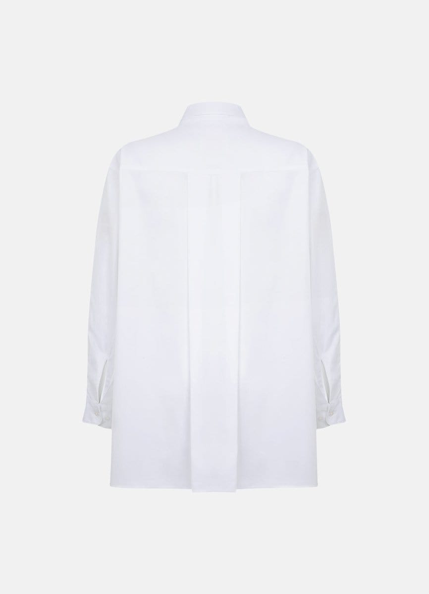 Terza oversized white cotton shirt with a back pleat and long sleeves, displayed on a plain background.