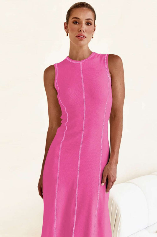 Woman wearing a sleeveless pink dress with white stitching, perfect for stylish summer outfits