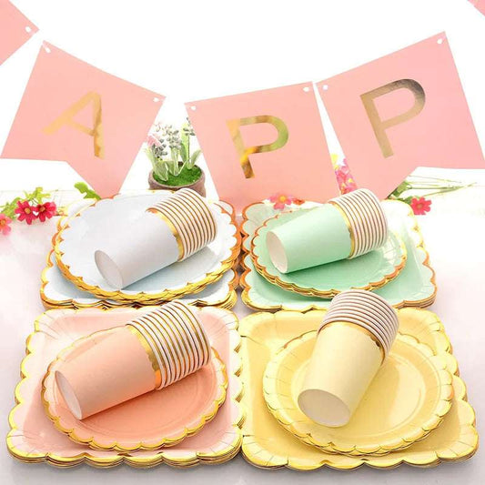 Pastel party tableware set with gold trim for a cheerful birthday celebration setup