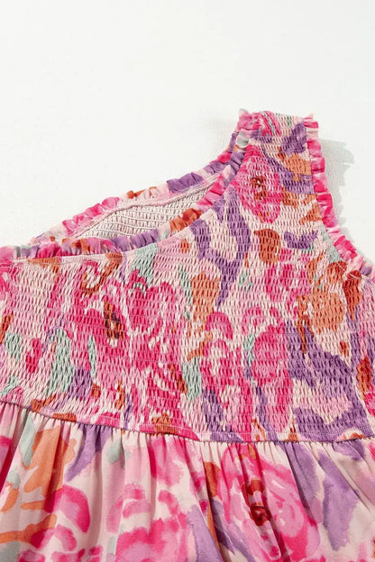 Multicolored floral dress with smocked neckline on a white background