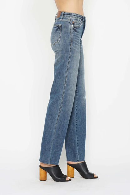 Blue jeans worn by a person on a white background
