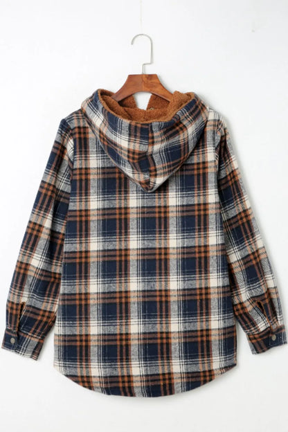 Plaid shirt with a hood on a hanger against a white background