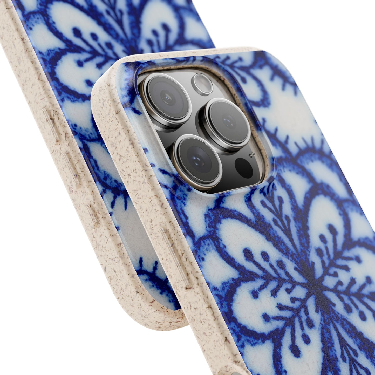 A close-up of a phone case with a blue and white floral pattern and a textured beige edge, shown fitted on a smartphone against a white background.