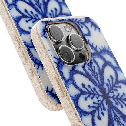 A close-up of a phone case with a blue and white floral pattern and a textured beige edge, shown fitted on a smartphone against a white background.
