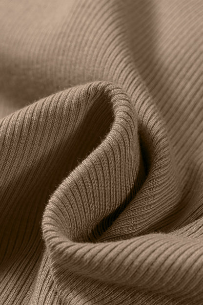 Close-up of folded tan ribbed fabric showing the vertical texture of the Slim Ribbed Padded Tank Top.