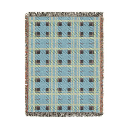 A rectangular woven throw blanket with a light blue, beige, and brown plaid pattern and fringed edges, shown flat against a white background.