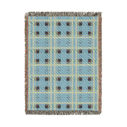A rectangular woven throw blanket with a light blue, beige, and brown plaid pattern and fringed edges, shown flat against a white background.