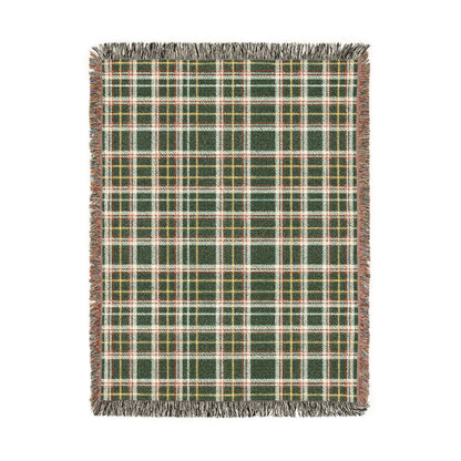 A rectangular woven throw blanket with a green, beige, and yellow plaid pattern and fringed edges, shown flat against a white background.