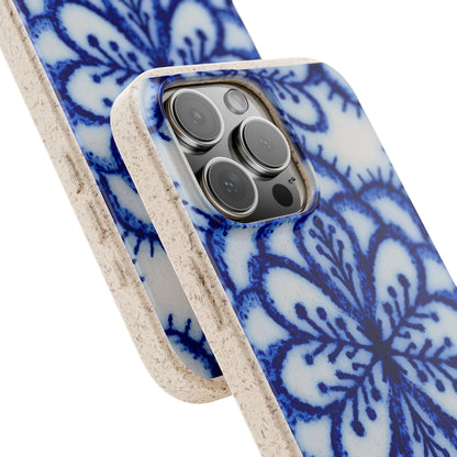 A close-up of a smartphone case with a blue floral or mandala-style pattern on a white background and a natural beige textured edge, shown fitted on a phone against a clean white backdrop.
