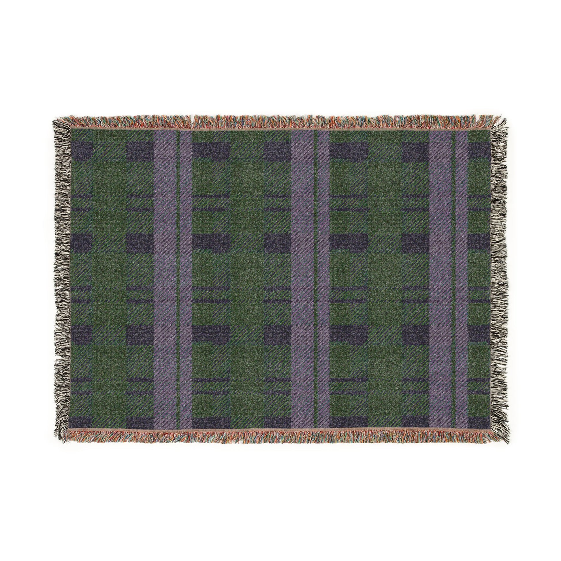 A rectangular woven placemat with a green and purple plaid pattern and fringed edges, shown flat against a white background.
