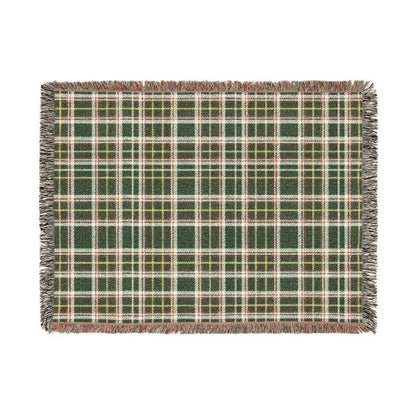 A rectangular woven throw blanket with a green, red, beige, and white plaid pattern and fringed edges, shown flat against a solid white background.