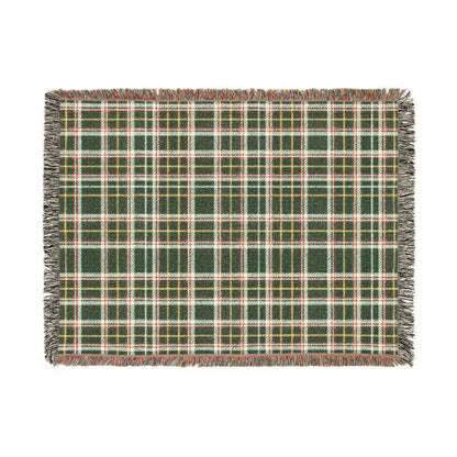 A rectangular woven throw blanket with a green, beige, and white plaid pattern and fringed edges, shown flat against a solid white background.