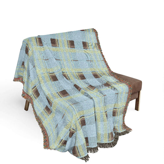 Plaid blanket draped over a chair on a white background