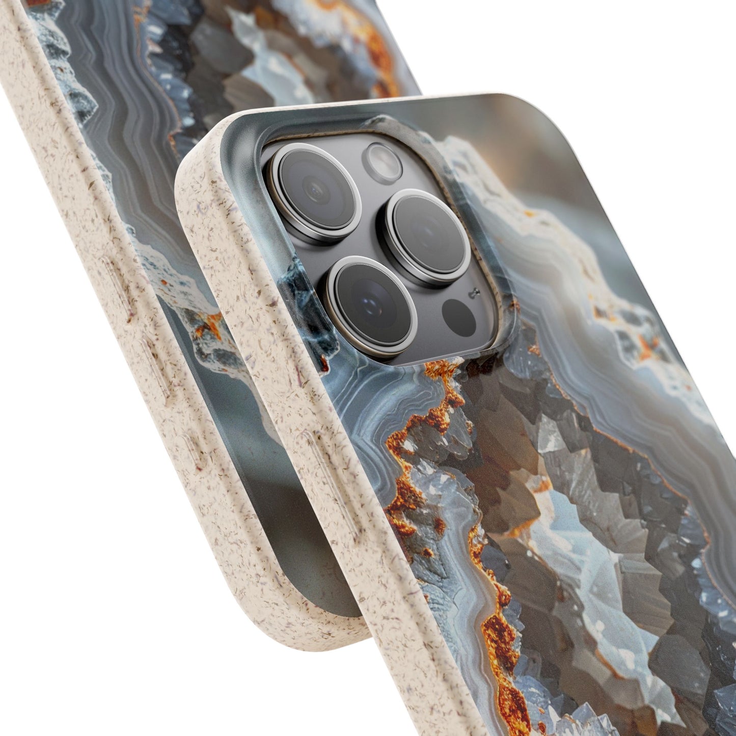 A close-up of a smartphone case with a geode or agate-inspired pattern in gray, white, and brown, with a textured beige bumper edge, shown on a phone against a white background.