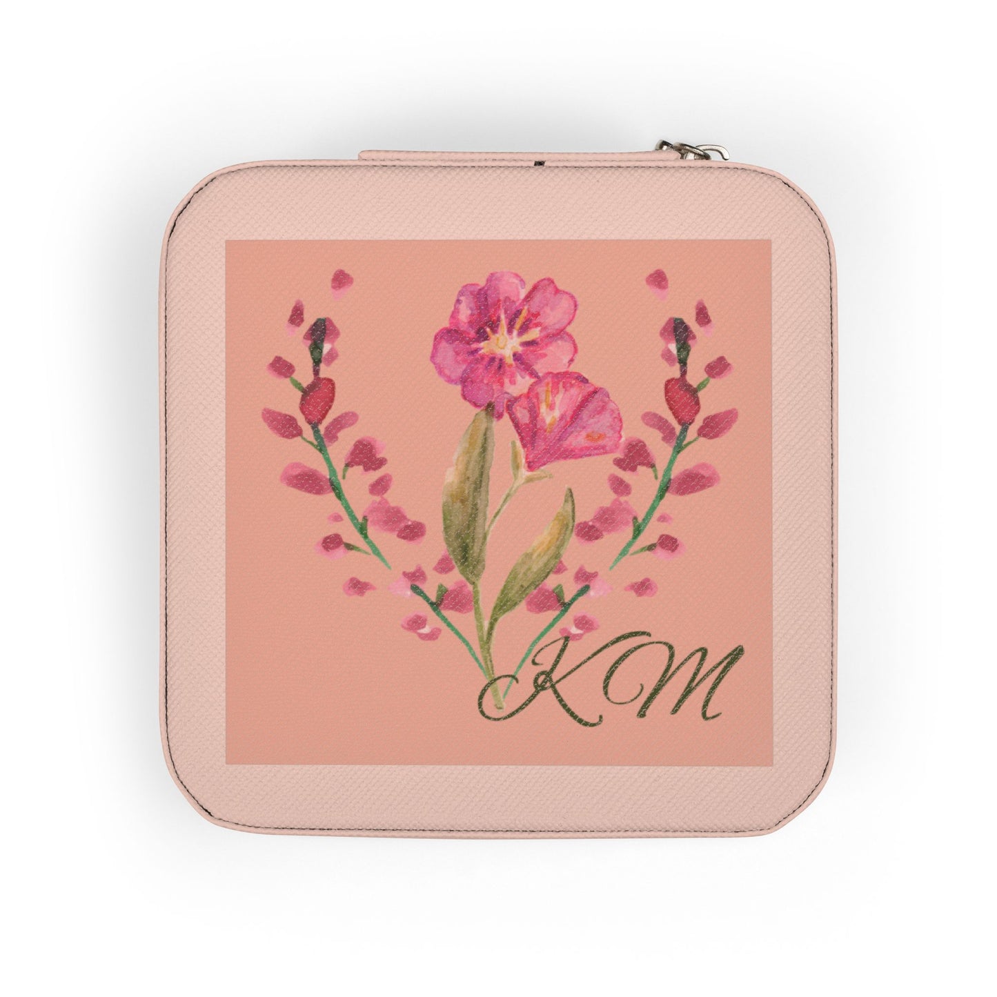A square zippered pouch in a light pink textured material, featuring a central square print with a pink flower illustration and the initials 'KM' in black script.